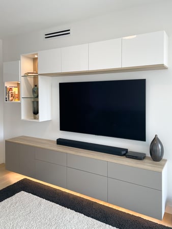 Media unit with white upper cabinets and grey lower floating cabinets