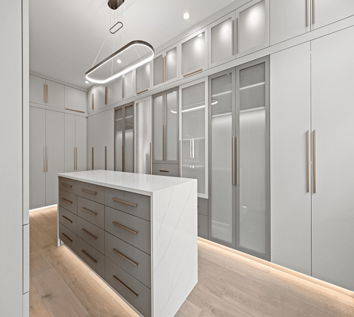 Luxury custom walk-in closet with closet organization ideas, closet accessories, shelving units, drawers, and island in Bloomfield Hills, Michigan by California Closets Greater Detroit