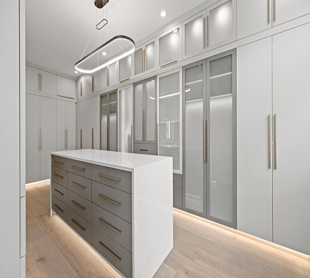 Luxury custom walk-in closet with closet organization ideas, closet accessories, shelving units, drawers, and island in Bloomfield Hills, Michigan by California Closets Greater Detroit