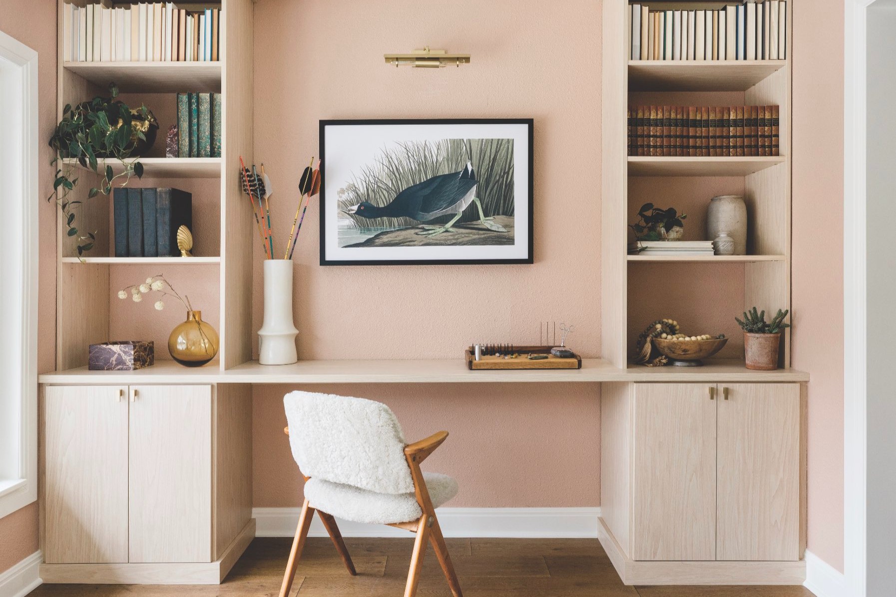 Custom home office with floor-to-ceiling shelving, file drawers, and organized workspace storage.