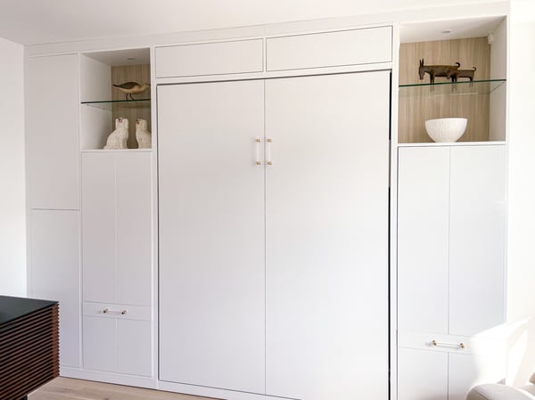 Modern, sleek wall bed that blends nicely with the white of the room