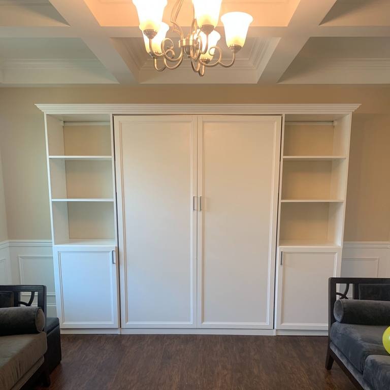 Greensboro - Custom closets - Closed Murphy bed unit with white bookshelves on each side