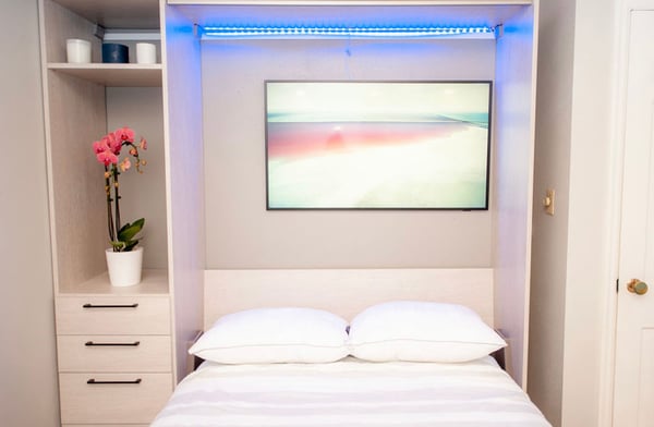 Murphy bed with desk, shelves, and cabinets in light wood finish by California Closets Cleveland, Ohio.