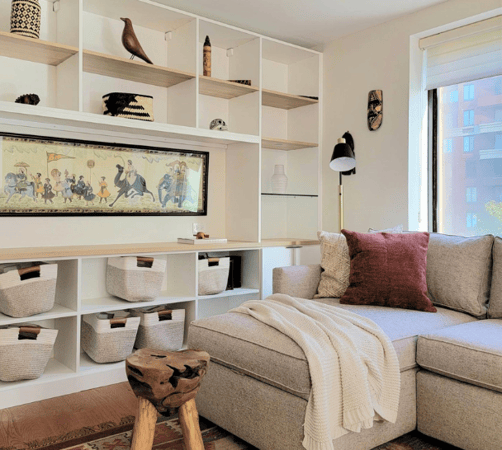 living room with white bookshelves floor to ceiling custom shelving for collectible items to display New York City