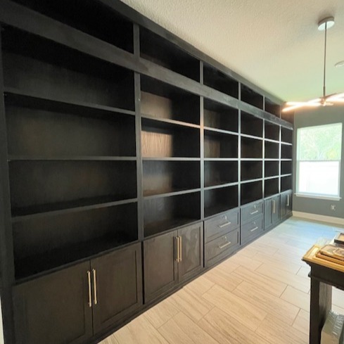 Library with Shadow Black finish and traditional round gold hardware.