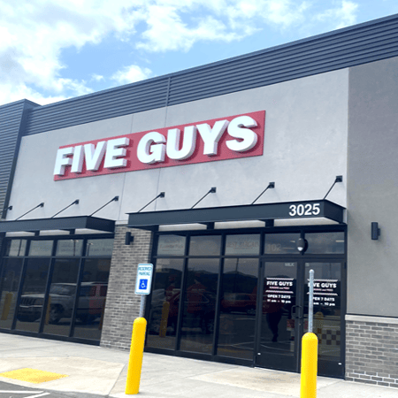 Exterior photograph of the Five Guys restaurant at 3025 S. Kinney Coulee Road in Onalaska, Wisconsin.