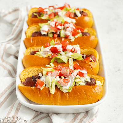 bacon wrapped blt hot dog with ranch lettuce tomato and minced shallot