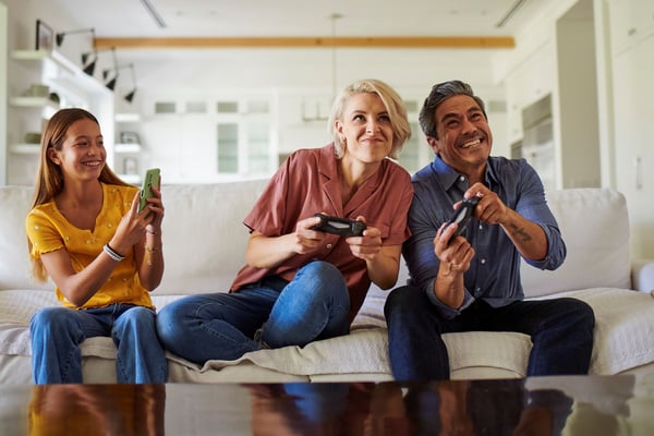 Family in Denver on couch playing video games