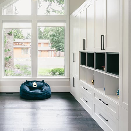 Custom closet design with shelves, drawers, and cabinets for workspace area by California Closets