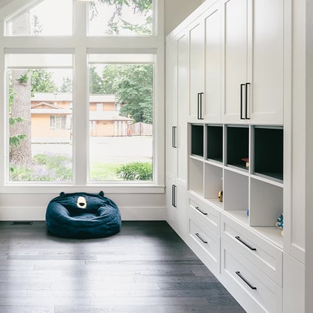 Custom closet design with shelves, drawers, and cabinets for workspace area by California Closets