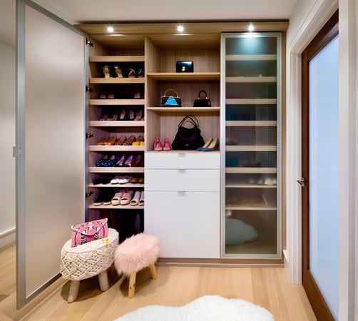 Stylish shoe closets with frosted glass doors, shoe shelves and white drawers in center