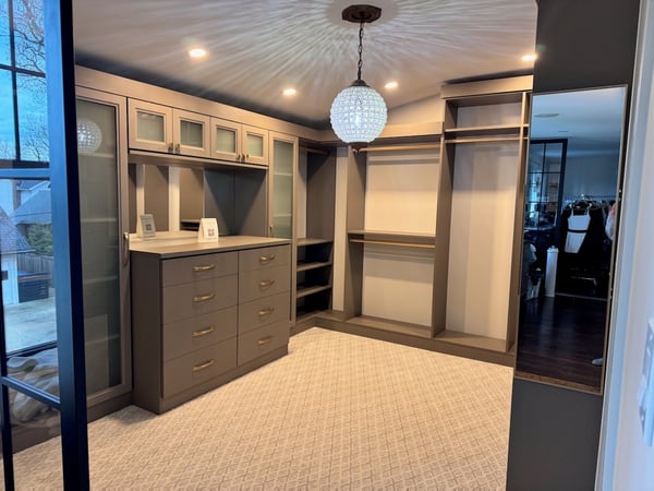 Walk in closet with jewelry storage and a lot of hanging space for clothes.