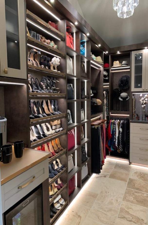 High style master walk-in closet with lighting and display to accentuate the collection