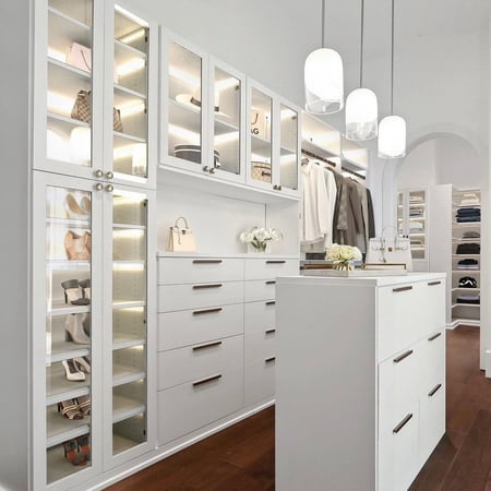 Custom closet organization with lighting for shoe shelving and dresser island California Closets Gulf Coast & New Orleans