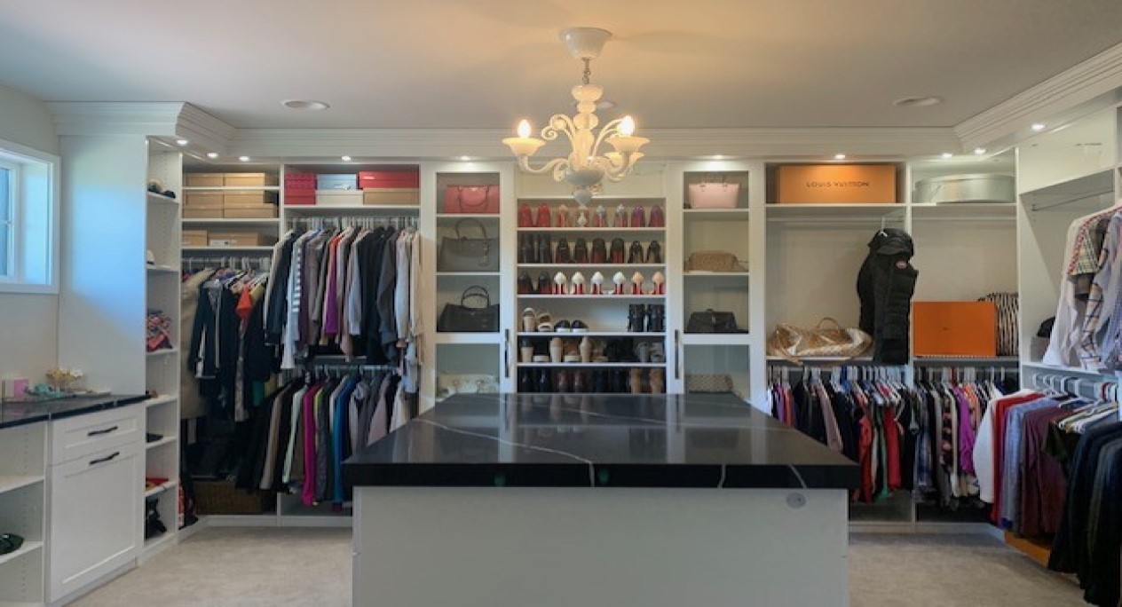 Large walk-in closet with island and vanity display