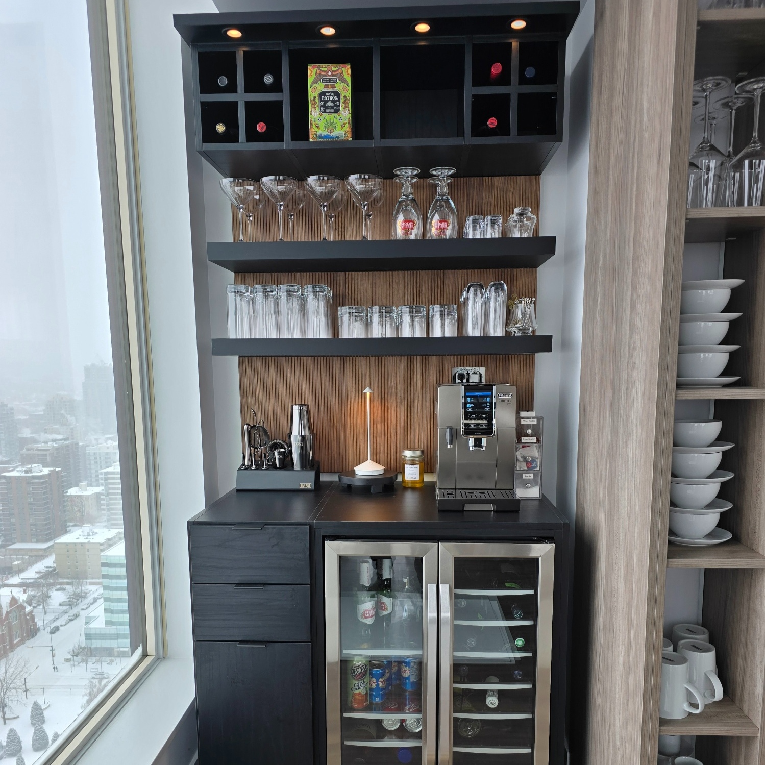 California Closets wine bar with upper wine storage, floating shelves, and lower drawers.