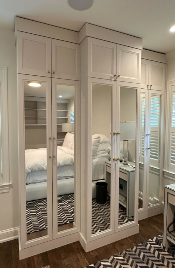 Bedroom wardrobe and closet storage with white and mirrored cabinets