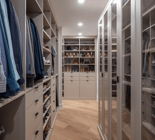 beige custom walk-in closet with glass doors, hanging, shelving, shoe wall, tilt-out hampers Manhattan New York