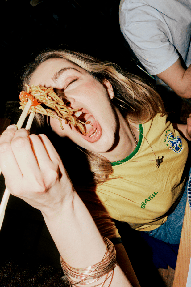 woman eating noodles with chopsticks