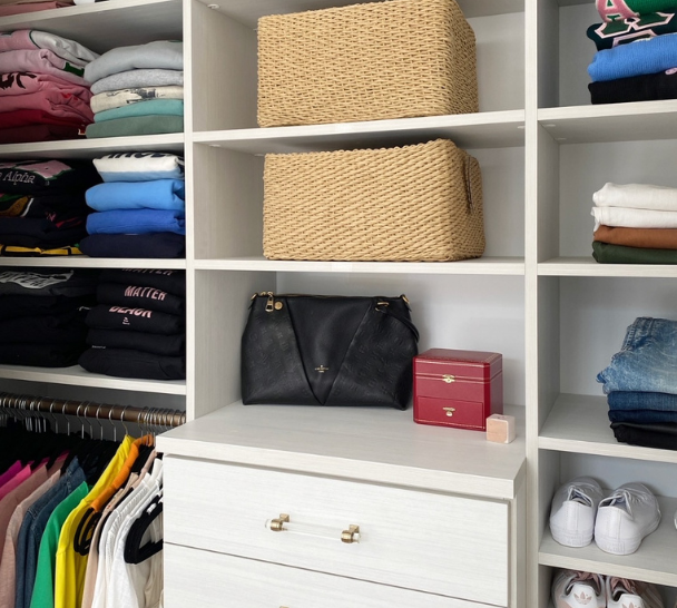 white walk-in closet with drawers, crystal gold hardware, shelving, hanging, and organized baskets for storage Chappaqua New York Westchester County NY