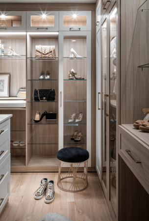 Img 3 California Closets Westchester County New York Two Toned White and Beige Large Walk-in Luxury Closet with Glass Shelving, Glass Doors, Lighting, and a Custom Center Island with Custom Jewelry Drawers