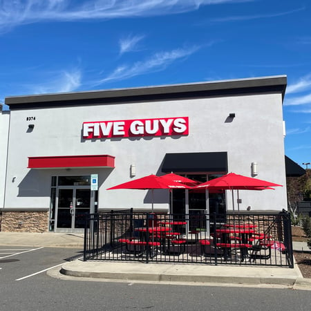 Exterior photograph of the entrance to the Five Guys restaurant at 8374 Charlotte Highway in Indian Land, South Carolina.