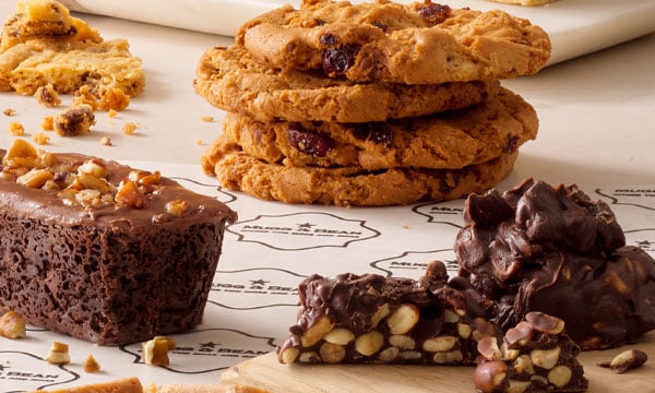 Freshly Baked treats from Mugg & Bean, including a Triple Chocolate Brownie, Chocolate Peanut Cluster, and Giant Choc Chip Cookies