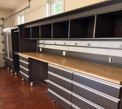 Garage storage with cabinets, drawers, workbench, and tool rack