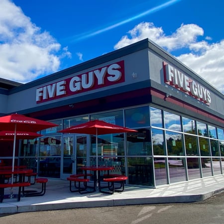 Exterior photograph of the entrance to the Five Guys restaurant at 10055 N. 2nd St. in Machesney Park, Illinois.