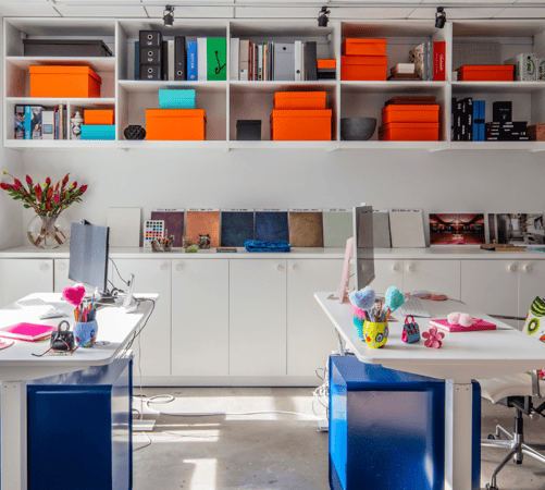 California Closets New York City Custom Commercial Space White Office Custom Bookshelves Storage Interior Design Studio with Closed Cabinets and two desk workspaces