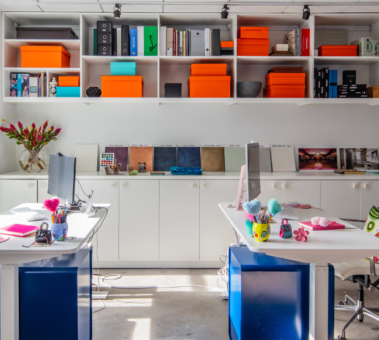 California Closets New York City Custom Commercial Space White Office Custom Bookshelves Storage Interior Design Studio with Closed Cabinets and two desk workspaces