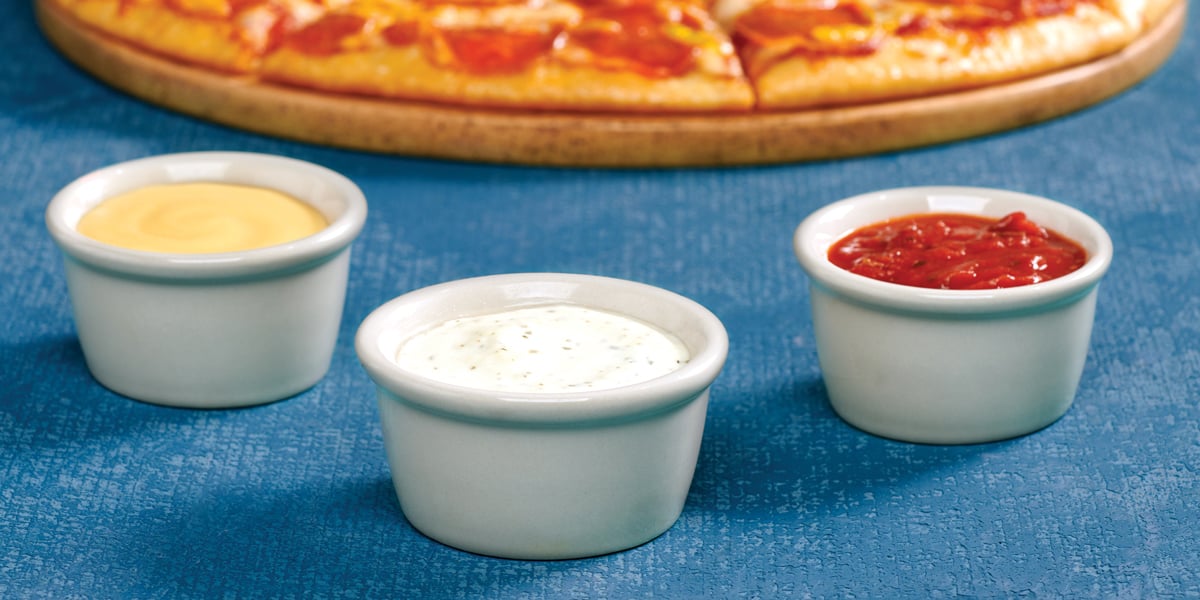 garlic butter, ranch, and marinara dipping sauces with pizza