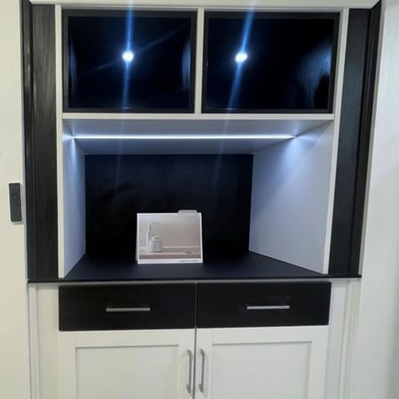 Custom espresso bar in closet with washed white and shadow black cabinetry.