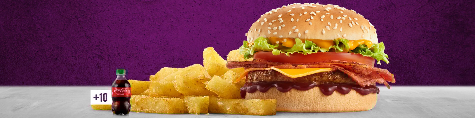 The Macon & Cheese burger with Chips on a grey surface with a purple background.