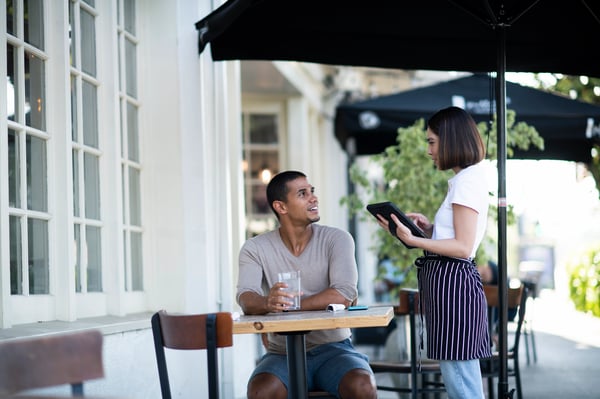 Waiter taking order in sidewalk cafe