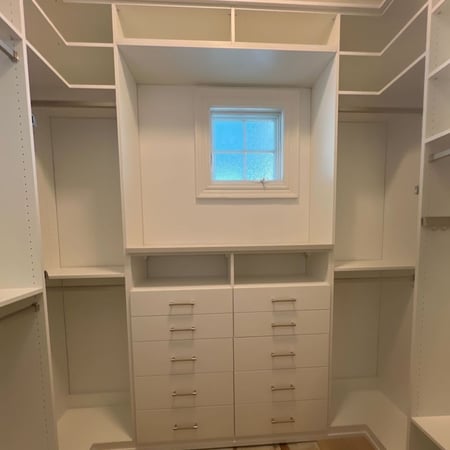 Virginia Beach - Custom closets - Walk-in closet with central drawers, hanging space, and overhead shelving.
