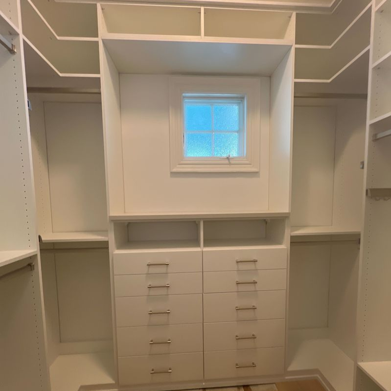 Virginia Beach - Custom closets - Walk-in closet with central drawers, hanging space, and overhead shelving.
