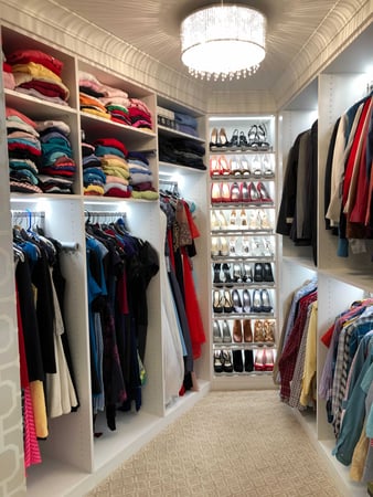 White Floor to ceiling walk-in closet with shoe wall and lighting