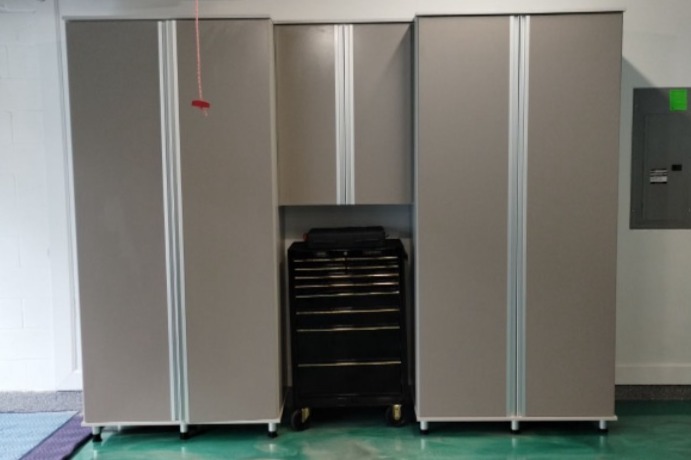 Custom garage storage in Shipshaw finish with matte aluminum extruded handles, extra support legs, and tailored design to work around client’s toolbox.