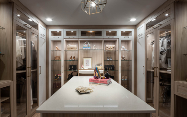 Img 2 -California Closets Westchester County New York Two Toned White and Beige Large Walk-in Luxury Closet with Glass Shelving, Glass Doors, Lighting, and a Custom Center Island with Custom Jewelry Drawers