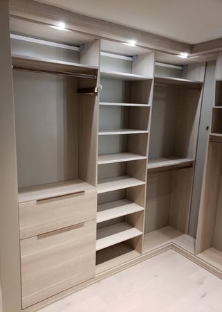 Floor-to-ceiling shelves paired with closet dividers for organization.