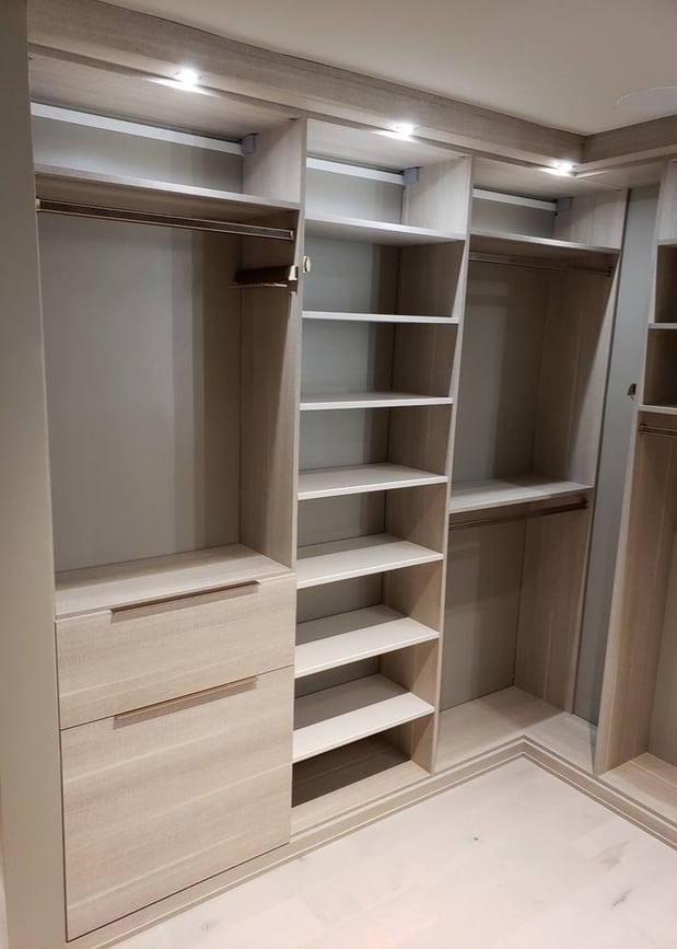 Floor-to-ceiling shelves paired with closet dividers for organization.
