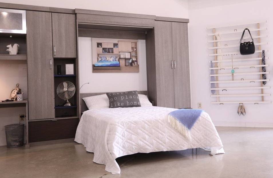 A beautifully organized bedroom featuring wall organizers for a clean, elegant space.