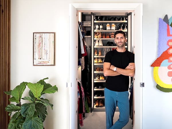 Custom closet with a shoe rack and framed photo