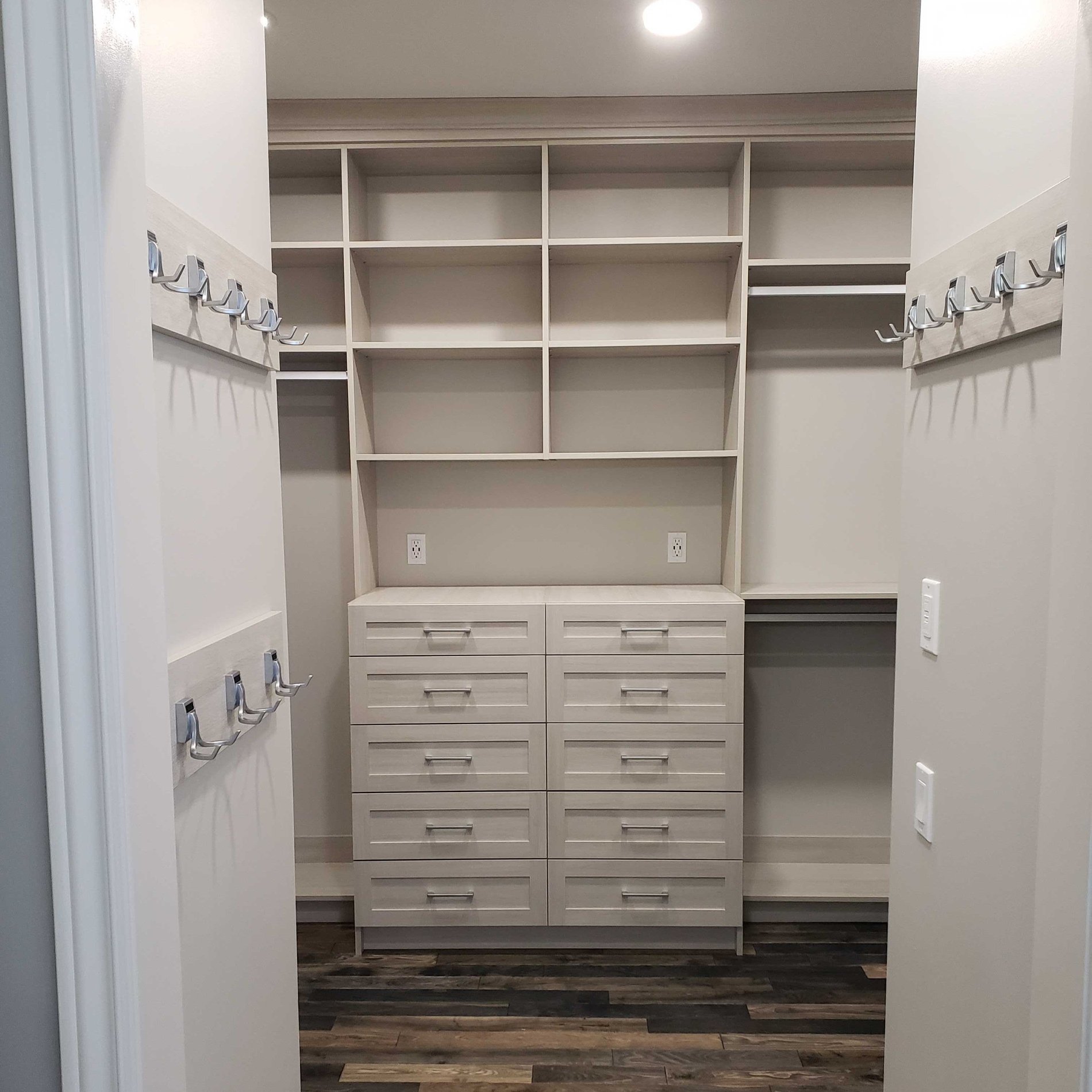 Custom Walk In Closet has hooks, drawers, shelves and puck lighting