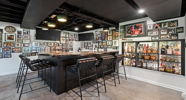 Custom Bar with photos, glass backsplash, and L-shaped bar