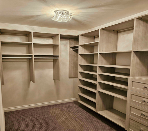 custom walk in closet with shelves, drawers, and hanging space in Lake Orion, Michigan.