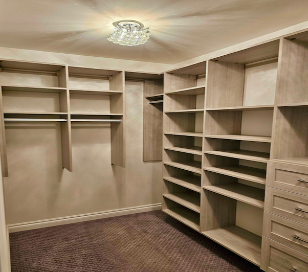 custom walk in closet with shelves, drawers, and hanging space in Lake Orion, Michigan.