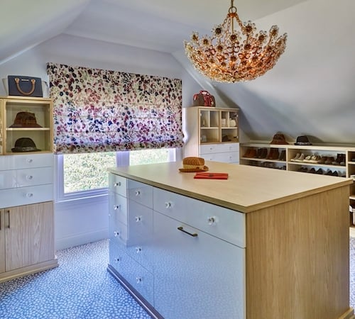 Attic walk-in closet with cabinets and gloss finishes by California Closets Chicago.