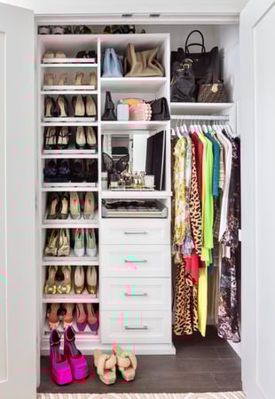 Reach-in closet in white with drawers, shoe shelves and hanging space by California Closets Northern New Jersey.
